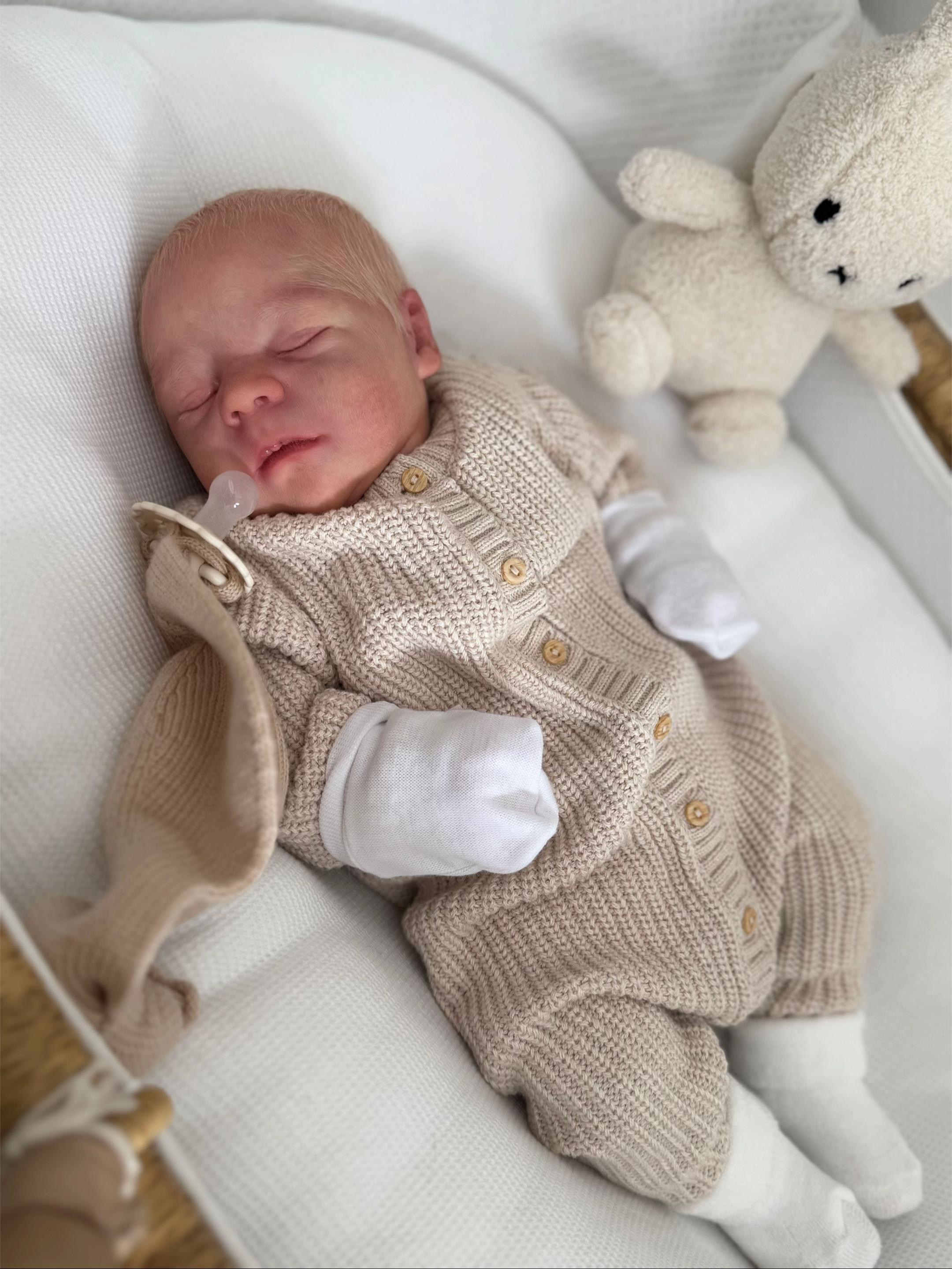 Baby Casper, a 17-inch realistic full body vinyl sleeping reborn baby doll boy with hand-rooted blonde hair by Reborn Heaven.