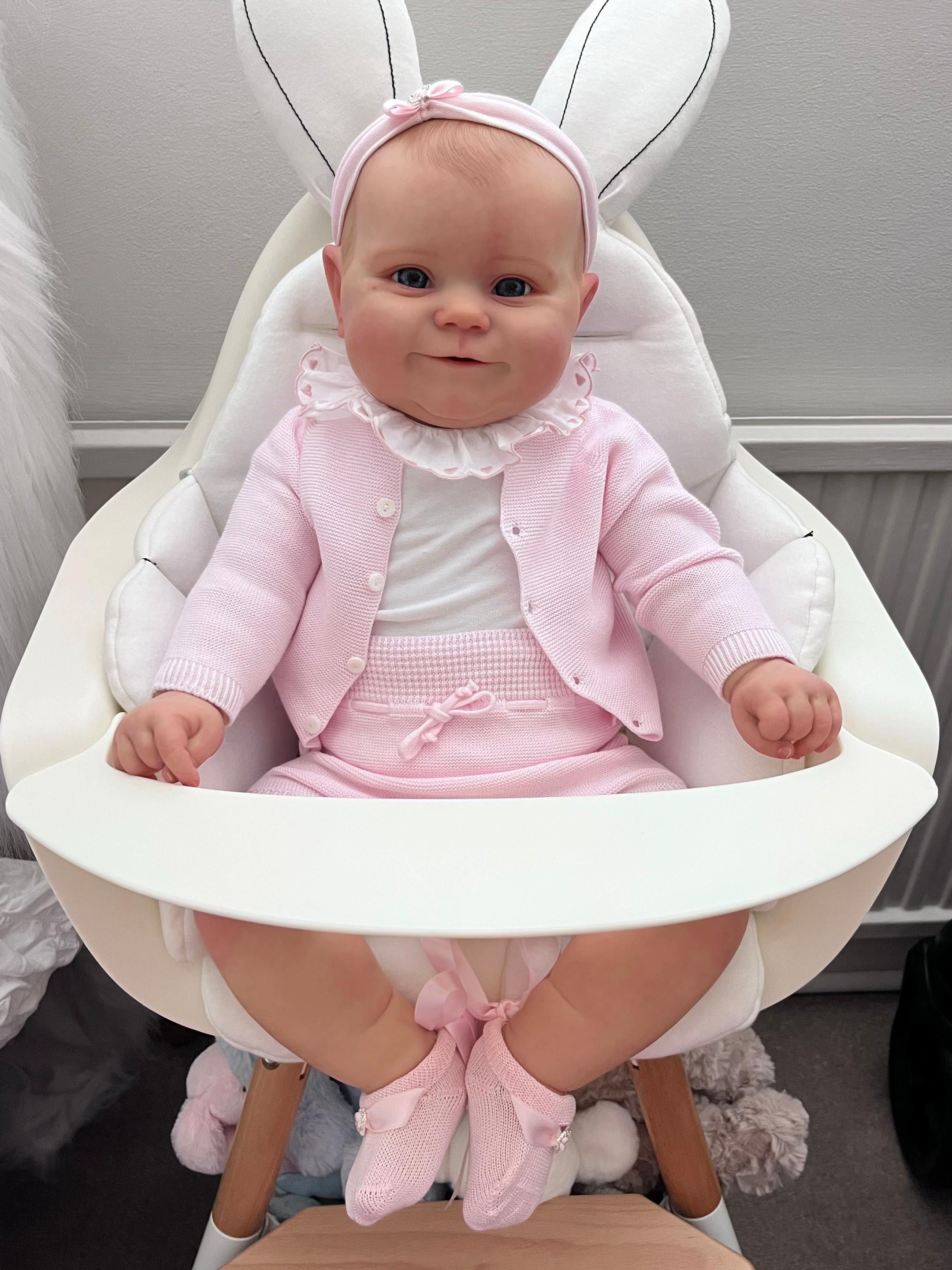 Baby Lily, a 25-inch realistic full body vinyl toddler reborn baby doll girl with hand-painted hair and open eyes by Reborn Heaven.